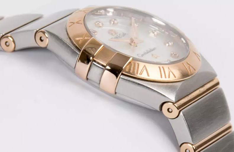 The white dial fake watch has diamond hour marks.